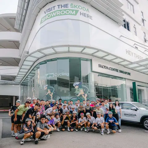 Group of cyclists outside the Škoda Centre Singapore showroom